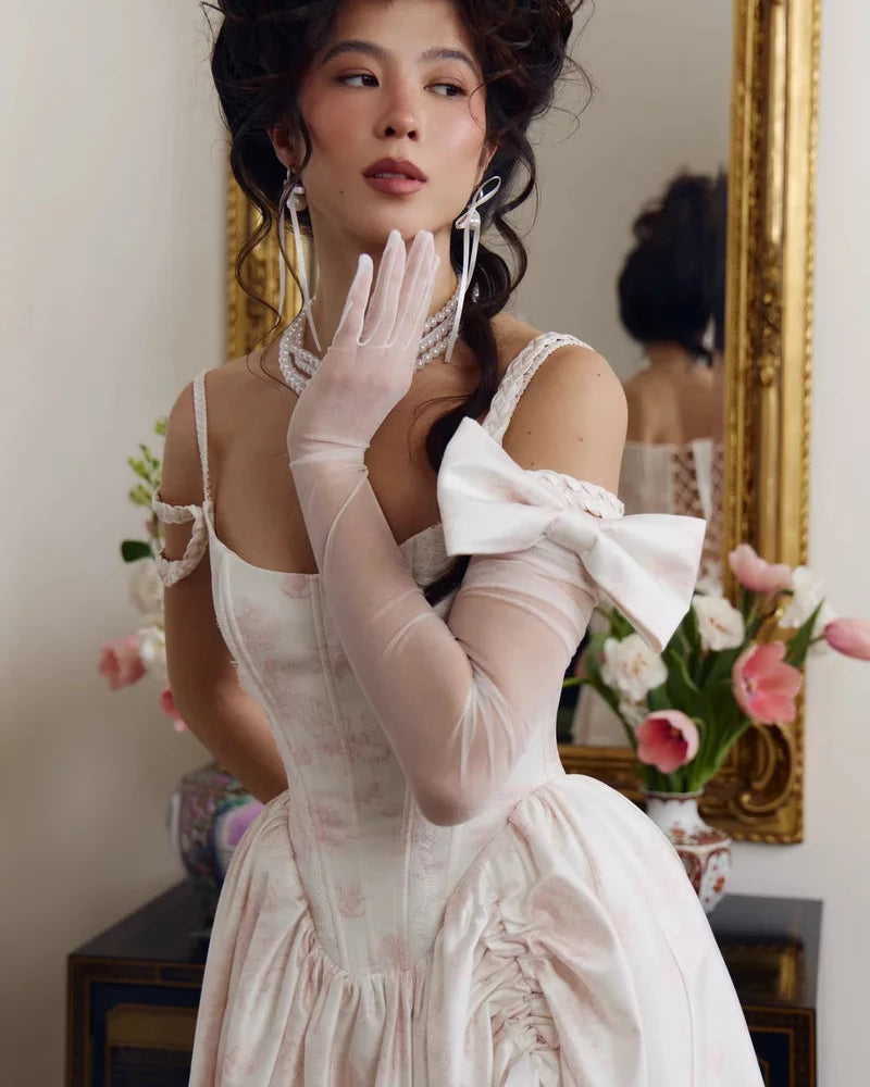Long stretch mesh opera gloves in ivory, full-length view with a satin bow at the elbow