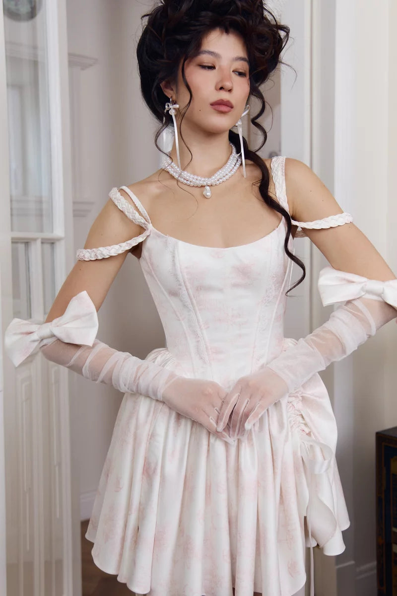 Ivory stretch mesh gloves worn on both arms with fingerless tips and satin bow accents