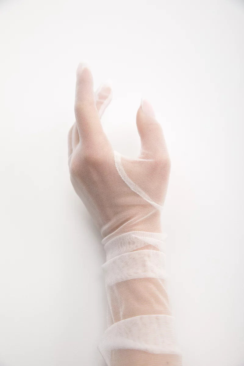 Ivory stretch mesh glove close-up on the hand and wrist, showing sheer fabric texture