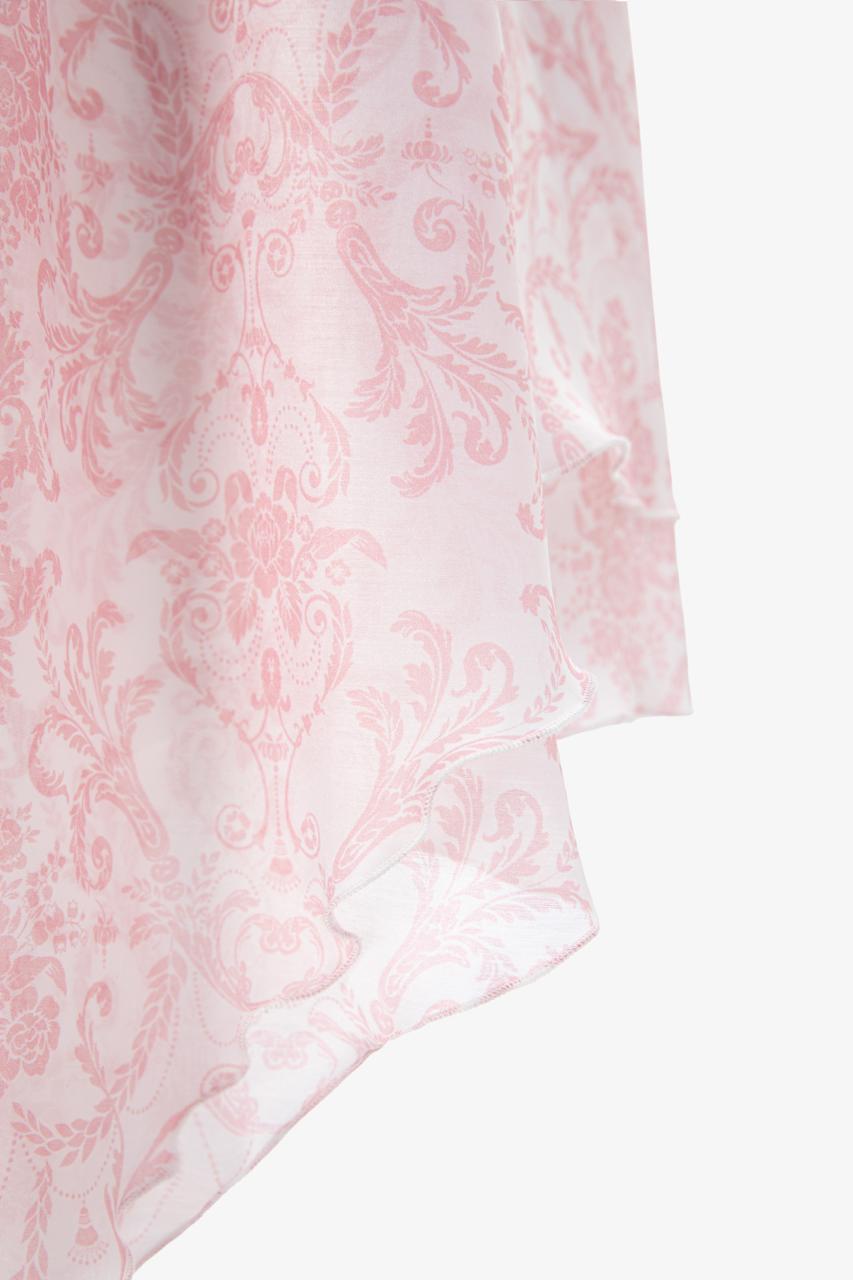 A close-up of a sheer light pink fabric Elisabeth luxury organza dress by Sadovska.