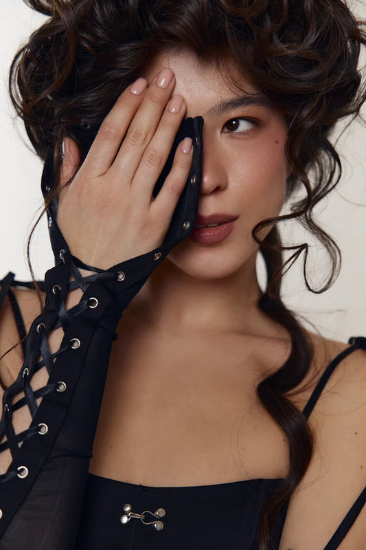 Black stretch mesh glove fingerless mitt with crisscross lacing between two rows of metal eyelets